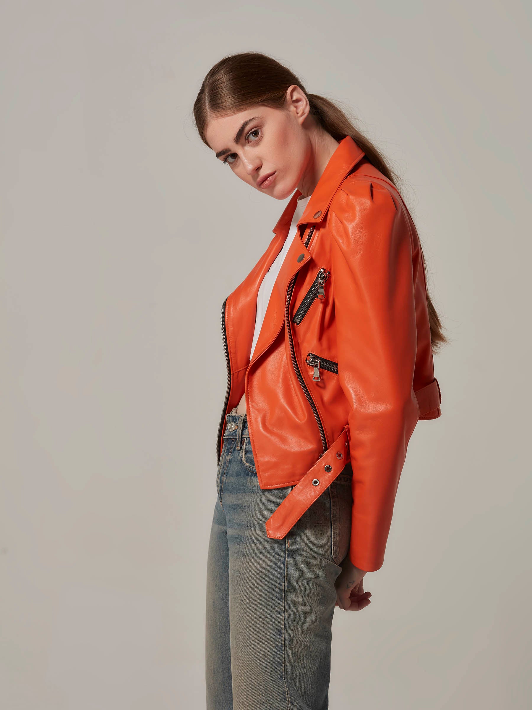 Orange Cropped Leather Motorcycle Jacket with Puffy Shoulders side close up